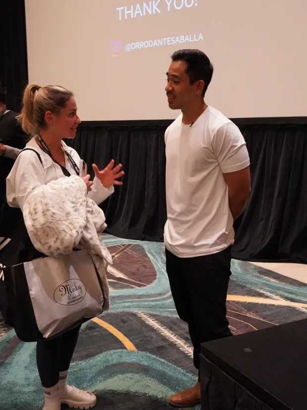 Dr. Rodante Saballa talking with an attendee after his session.
